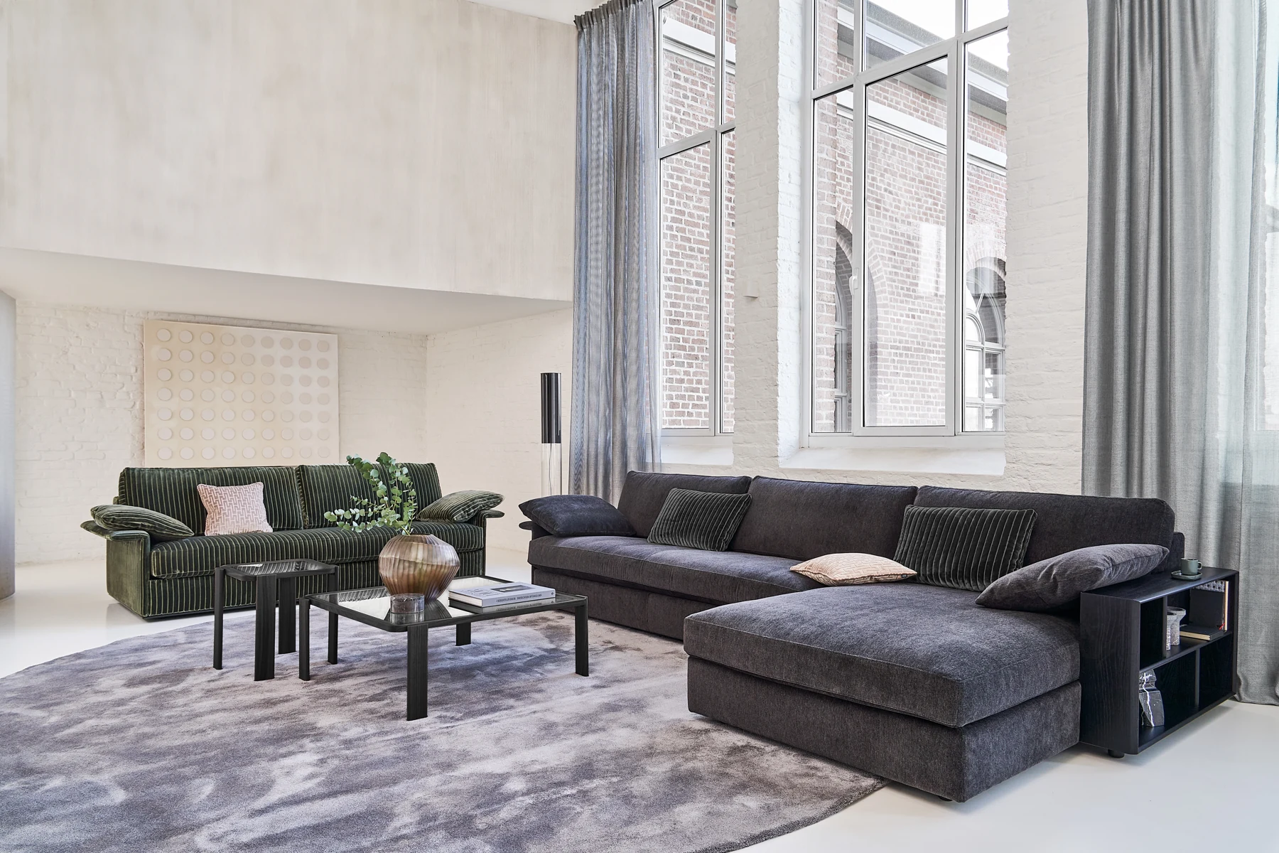 Inspiration Sofakombination mit Longchair in dunklem Stoff vor hohen Fenstern